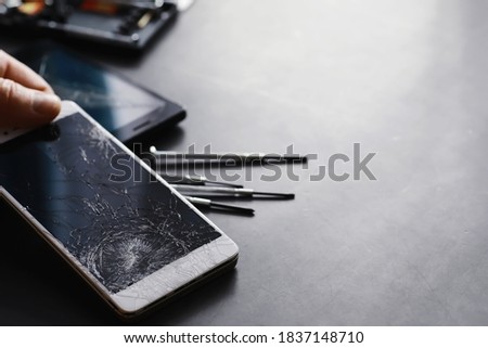 Smartphone with a broken touch screen. Mobile phone broken. The phone crashed. Replacing broken glass on a cell phone. Smartphone repair.