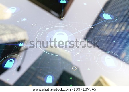 Double exposure of virtual creative lock hologram with chip on modern skyscrapers background. Information security concept
