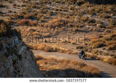 man with black road motorcycle