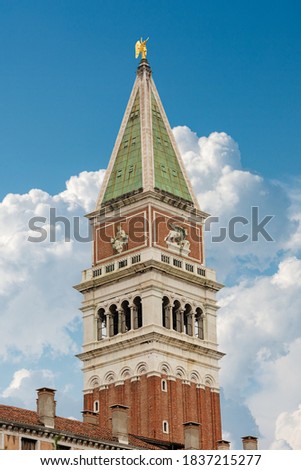 Venice, Campanile di San Marco (bell tower) in St. Mark square, on blue sky with clouds. UNESCO world heritage site, Veneto, Italy, Europe.