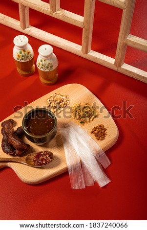 Fast food vietnam, rice paper with spices, chilli paste, onion fat, salt, peanut, fried onion, dried shrimps look delicious with red background