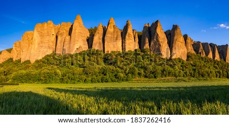 Sunset on monolith rock formation called "Les Pénitents" near the village of Les Mées. The geologic formation was named for resemblance to monks. Alpes-de-Haute-Provence, PACA Region, France Royalty-Free Stock Photo #1837262416