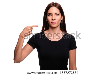 Isolated in white background brunette woman saying letter G in spanish sign language