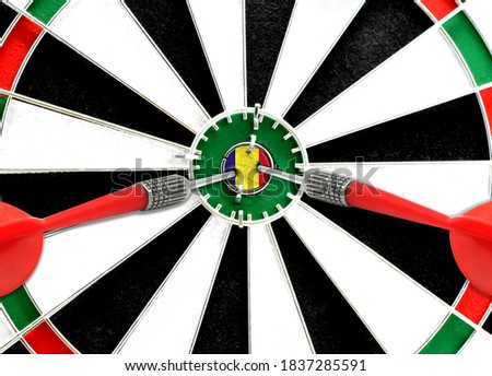 Close-up of a dart board with an imprinted flag of Romania in the center. The concept of achieving goals.