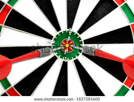 Close-up of a dart board with an imprinted flag of Macedonia in the center. The concept of achieving goals.