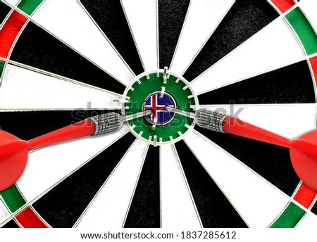 Close-up of a dart board with an imprinted flag of Iceland in the center. The concept of achieving goals.
