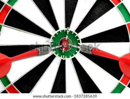 Close-up of a dart board with an imprinted flag of Afghanistan in the center. The concept of achieving goals.