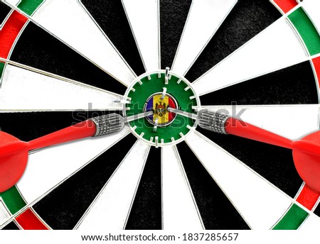 Close-up of a dart board with an imprinted flag of Moldova in the center. The concept of achieving goals.