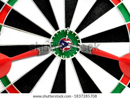 Close-up of a dart board with an imprinted flag of Puerto Rico in the center. The concept of achieving goals.