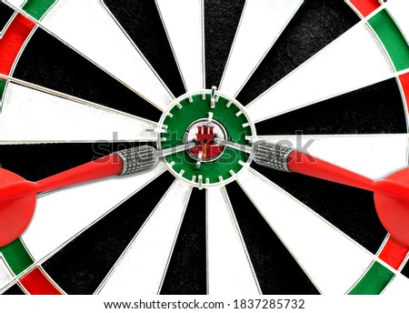 Close-up of a dart board with an imprinted flag of Gibraltar in the center. The concept of achieving goals.