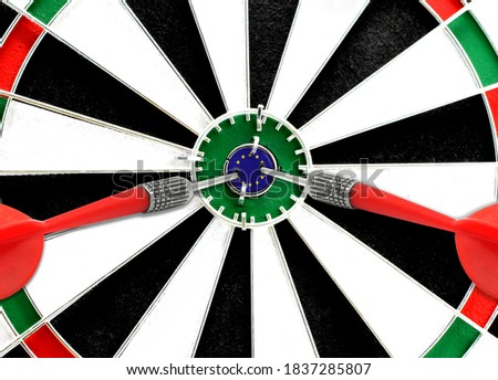 Close-up of a dart board with an imprinted flag of European Union in the center. The concept of achieving goals.