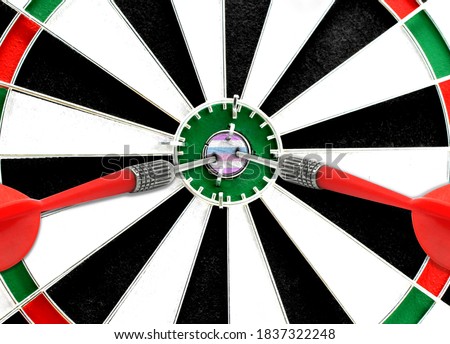 Close-up of a dart board with an imprinted flag of bigender pride in the center. The concept of achieving goals.