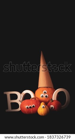 Group of Halloween pumpkins, with googly eyes, on the dark background, funny pumpkin, orange, wizard pumpkin, word boo, funny, Halloween for kids