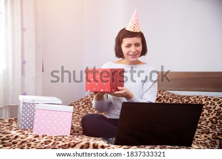 Woman celebrating birthday, Cristmas or New Year online in quarantine time.