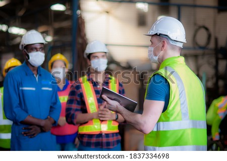 manager or leader are training and assignmenting a job for team of technicians, supervisor, foreman and engineers In the morning meeting before work In which everyone wear masks to prevent coronavirus Royalty-Free Stock Photo #1837334698