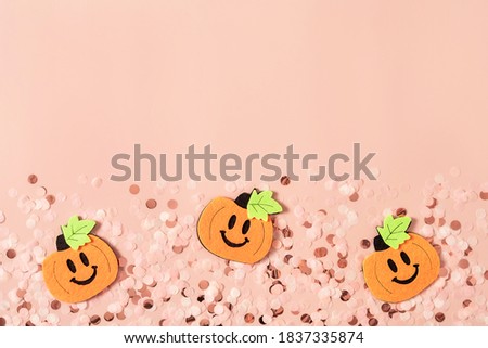 Modern abstract pastel pink background with round confetti and cartoon Halloween pumpkins. Great design for any purposes. Holiday party decoration concept. Greeting card. Banner design. Vintage paper