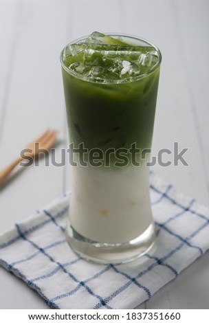 iced matcha latte green tea on white table background.
