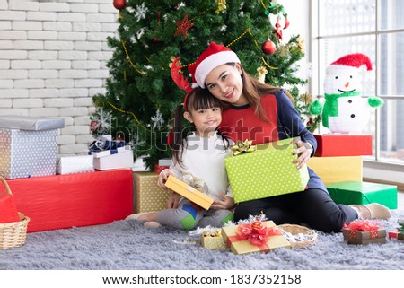 portrait mother and cute daughter feeling happy and enjoy with Christmas gift