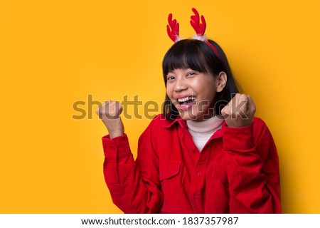 Portrait beautiful asian women wear santa christmas hat showing okay for good hand sign feeling so happiness and confident

