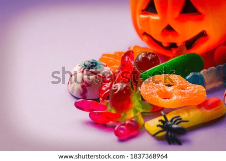 halloween candies seen close up on lilac background