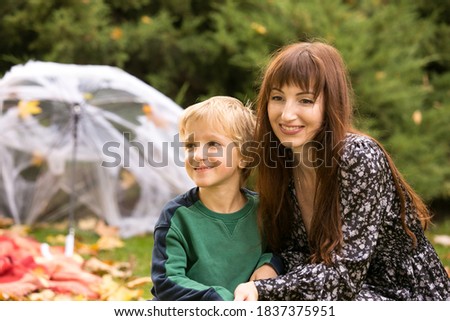 Halloween. Happy family - mom and son at a Halloween picnic. Warm autumn October day.