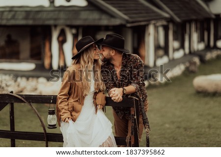 Loving couple on a  ranch in the western mountains in the autumn season. Elopement concept Royalty-Free Stock Photo #1837395862
