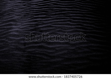 Dark purple colored shaded sands of the desert. Background and texture for modern design