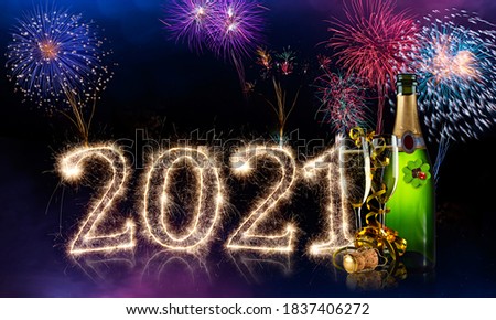 happy new year eve colorful fireworks sparkler 2021 number four leaf clover champagne bottle glass in front of red purple blue black bokeh night panorama background