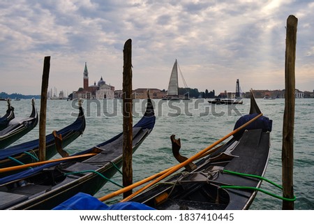 Image of Grand Canal and several gondola in Venice, with the island of San Giorgio Maggiore in the background