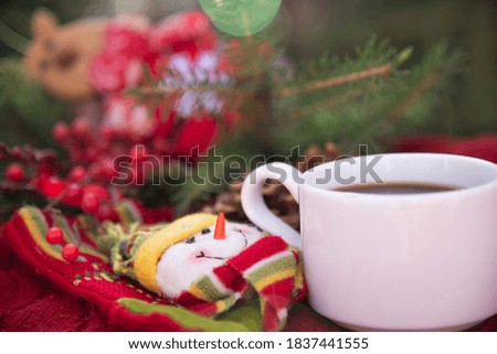 White  Cup on the background of Christmas decorations and Christmas tree 