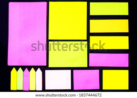 visual art composition from set of colored stickers on black background