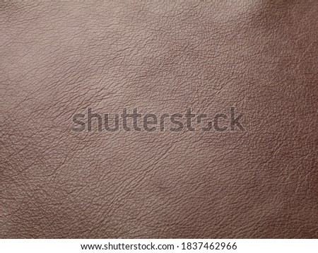 Genuine dark brown cattle leather texture background. Macro photo