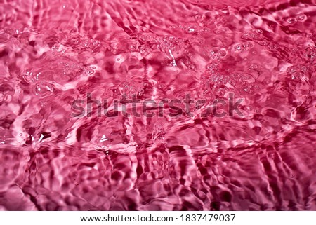 splash of water on a pink background. Abstract wallpaper