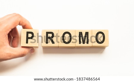 Word promo. Wooden small cubes with letters isolated on white background with copy space available.Business Concept image.