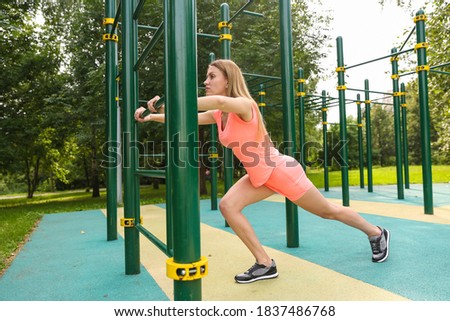 woman doing fitness exercises on sport ground outdoors