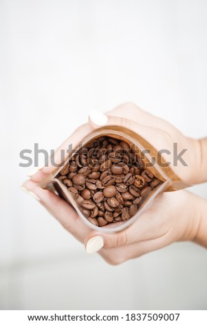 Coffee beans in the palms. Coffee aromaniac