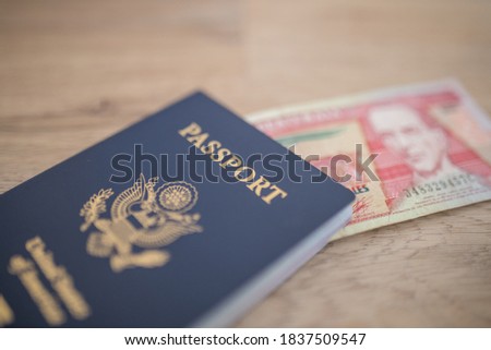 Picture of a United States of America Passport with a Blurry Ten Guatemalan Quetzales Bill Inside