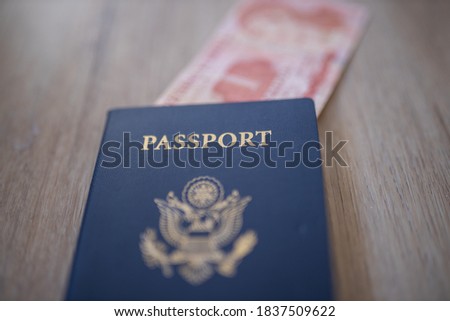 United States of America Passport with a Blurry One Honduran Lempiras Bill partially inside it