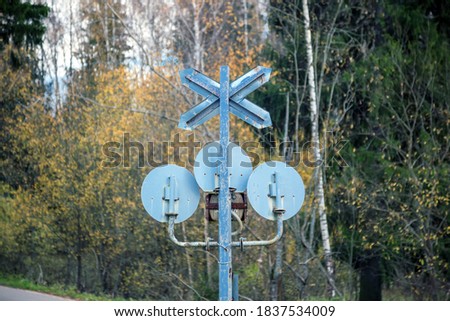 Reverse side of a traffic light close-up at a railway crossing. Railway crossing sign, single-track railway sign.