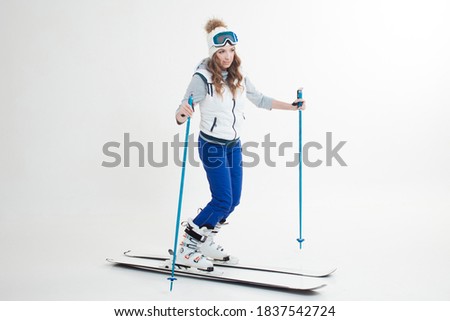 young woman goes skiing. Skier maneuvers on mountain skis, photos on a white background in the Studio, winter sports, Hobbies and a healthy lifestyle