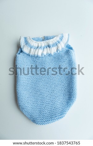 Knitted newborn costume in various colors and types.