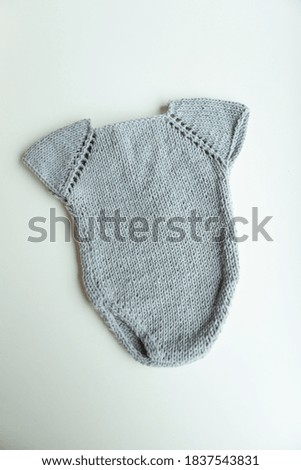 Knitted newborn costume in various colors and types.