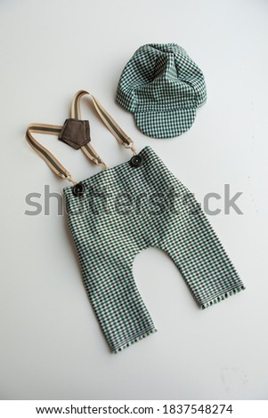 
Combed cotton clothes and newborn hats of various colors and types on a white background.