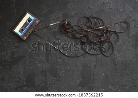 This shows a well known problem with the old fashioned compact cassettes: the tape used to come out, making the cassette useless Royalty-Free Stock Photo #1837562215