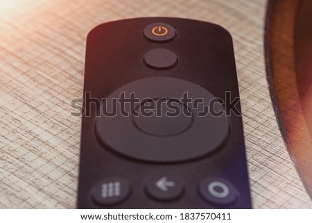 black plastic tv remote on the table