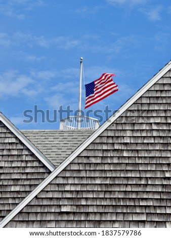 An American flag angles up in a stiff wind.  Block Island, RI.  Copy space.