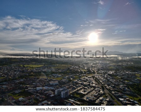 Top View Sunrise Rural landscape, sky, clouds, sun and city, morning