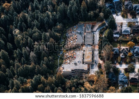 Aerial View of Residential Homes in a green neighborhood during a sunny morning. Located in North Vancouver, British Columbia, Canada. Modern City