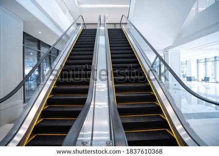 Modern luxury electric escalators with staircase 
