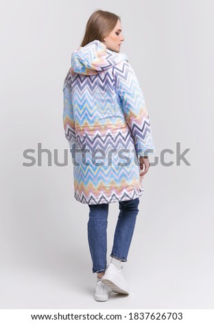young woman in an autumn jacket on a white background. advertising photo concept for store.